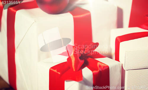 Image of close up of gift boxes and red christmas balls