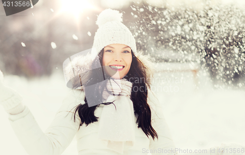 Image of happy woman with snow outdoors in winter