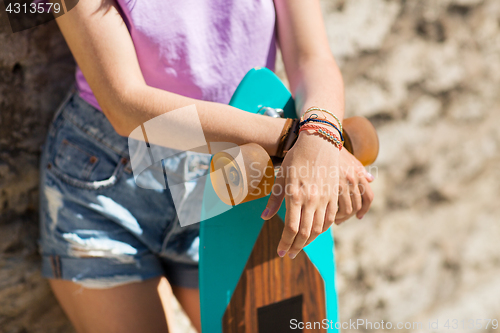 Image of close up of teenage girl with longboard