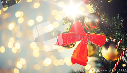 Image of close up of red bow decoration on christmas tree