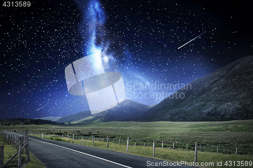 Image of night landscape of road and mountains over space