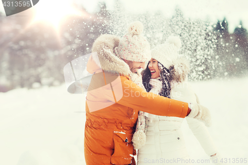 Image of happy couple hugging and laughing in winter