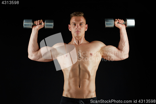 Image of man bodybuilder with dumbbells exercising