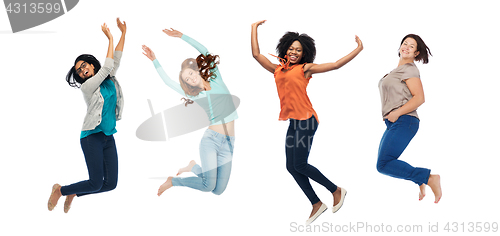 Image of happy women jumping in air over white background