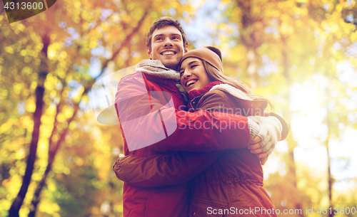 Image of happy young couple hugging in autumn park