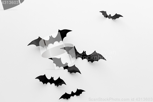 Image of black paper bats over white background
