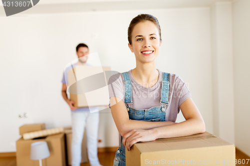 Image of happy couple with boxes moving to new home