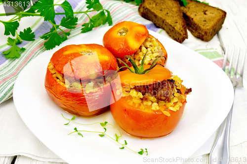 Image of Tomatoes stuffed with bulgur in plate on table