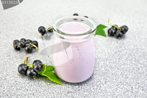 Image of Milk cocktail with black currant on granite table