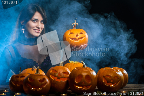 Image of Woman with Halloween pumpkins