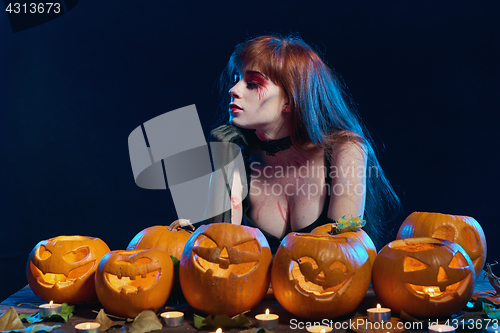 Image of Woman with Halloween pumpkins