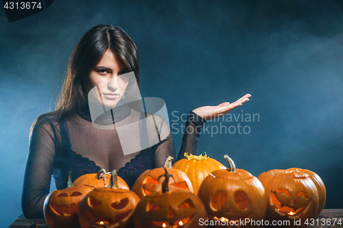 Image of Woman with Halloween pumpkins