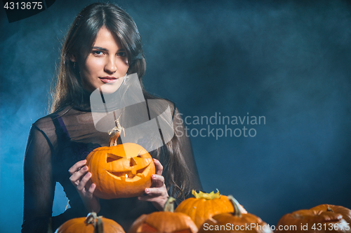 Image of Woman with Halloween pumpkins
