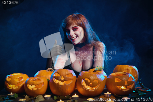 Image of Woman with Halloween pumpkins