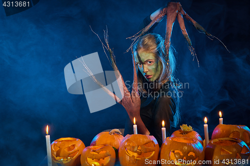 Image of Halloween costume woman, tree girl with pumpkins