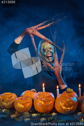 Image of Halloween costume woman, tree girl with pumpkins