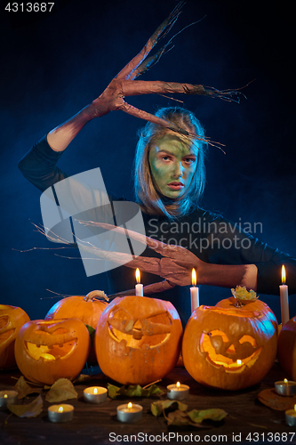 Image of Halloween costume woman, tree girl with pumpkins