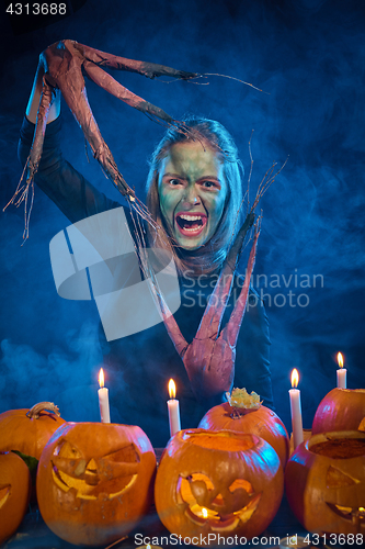 Image of Halloween costume woman, tree girl with pumpkins