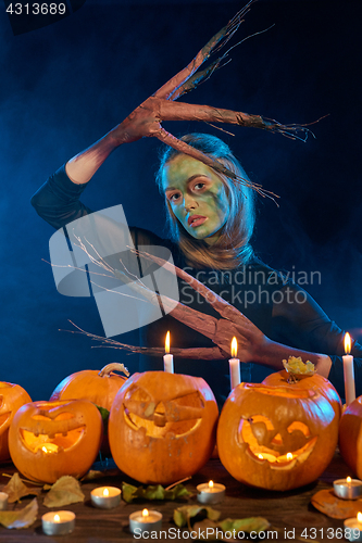 Image of Halloween costume woman, tree girl with pumpkins