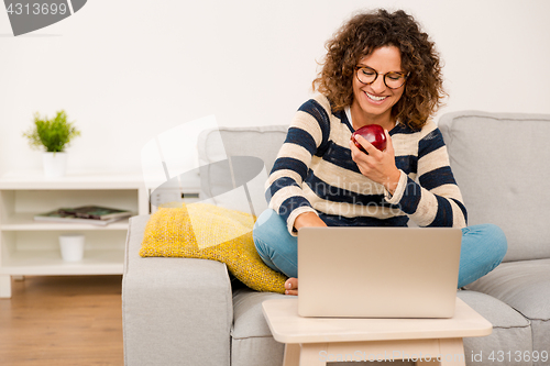 Image of Beautiful woman working at home