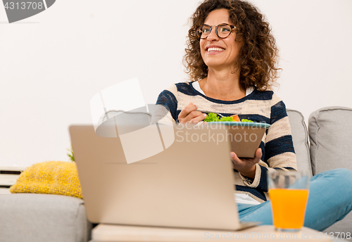 Image of Beautiful woman eating a salad