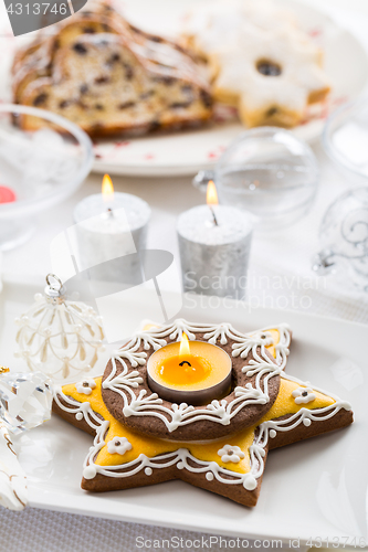 Image of Decorated Christmas table with gingerbread candle