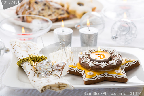 Image of Decorated Christmas table with gingerbread candle