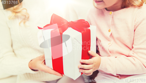 Image of close up of mother and little girl with gift box