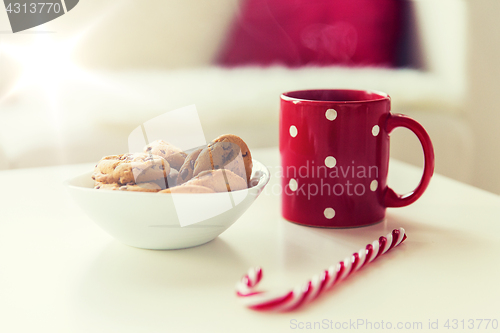 Image of close up of oat cookies, sugar cane candy and cup