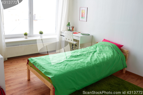 Image of kids room interior with bed, table and accessories