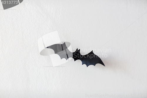 Image of halloween decoration of bat hanging on strings