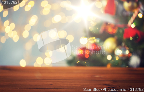 Image of empty wooden surface over christmas tree lights