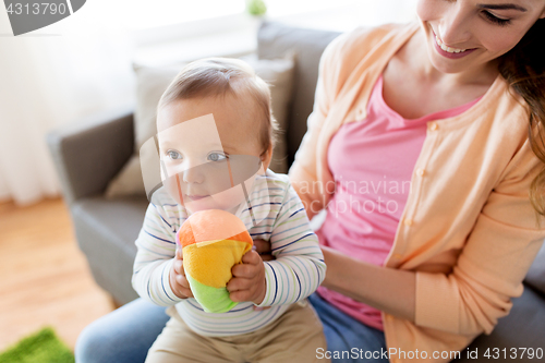 Image of happy young mother with little baby at home