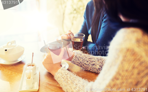 Image of close up of couple drinking tea at cafe