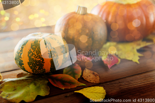 Image of close up of pumpkins on wooden table at home