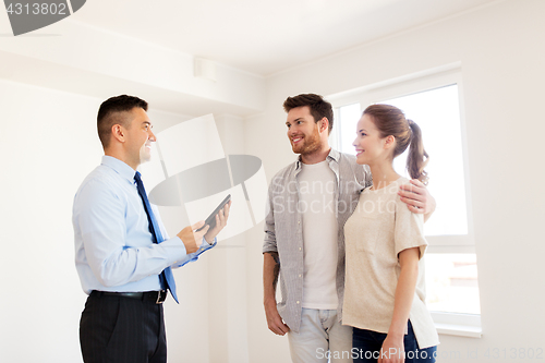 Image of couple and realtor with tablet pc at new home