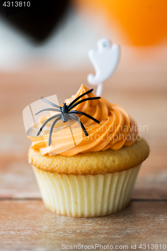 Image of cupcake with halloween decoration on table