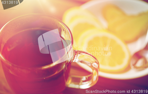 Image of tea cup with lemon and ginger on plate