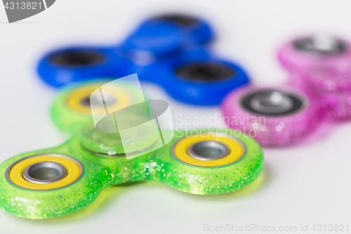 Image of close up of fidget spinners on white background