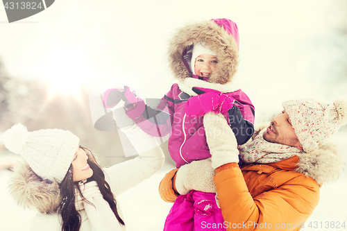 Image of happy family with child in winter clothes outdoors