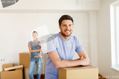 Image of happy couple with boxes moving to new home