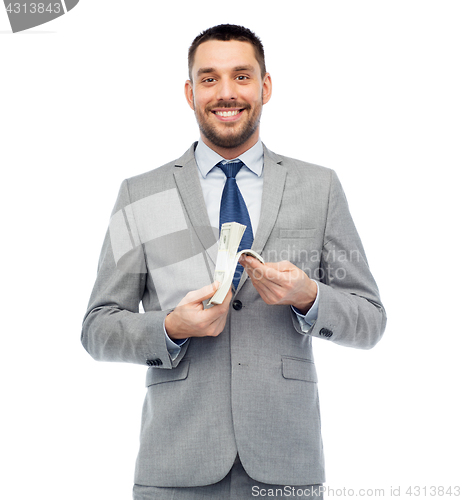 Image of smiling businessman with american dollar money