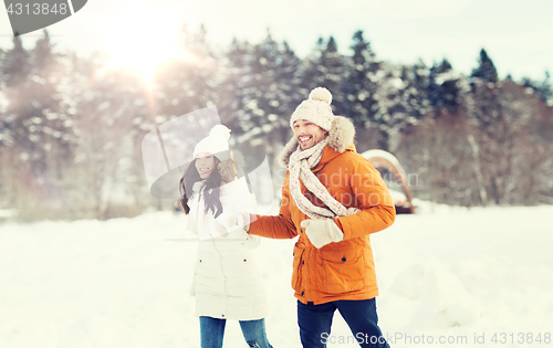 Image of happy couple running over winter background