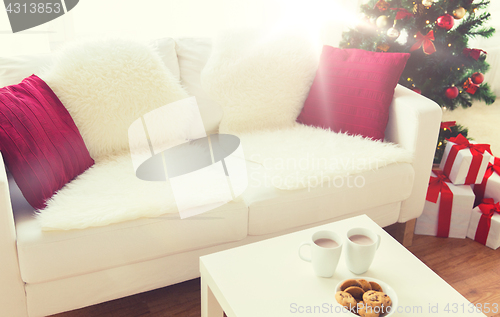 Image of close up of christmas cookies and cups on table