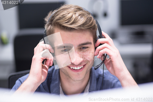 Image of male call centre operator doing his job