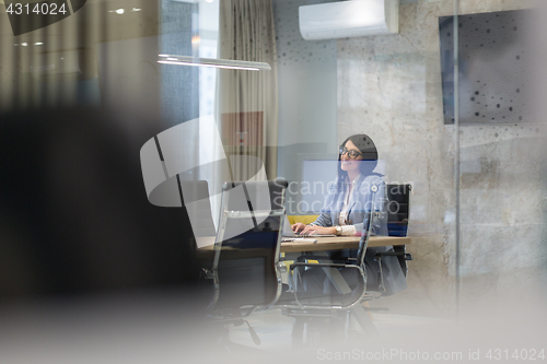 Image of businesswoman using a laptop in startup office