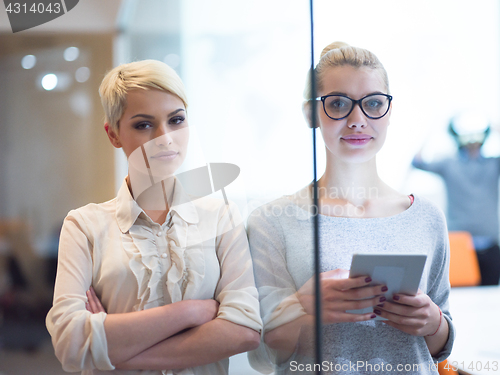 Image of Pretty Businesswomen Using Tablet In Office Building during conf