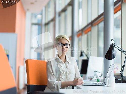 Image of businesswoman using a laptop in startup office