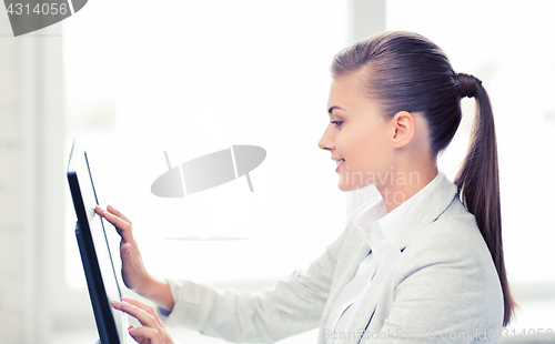 Image of smiling businesswoman with touchscreen in office