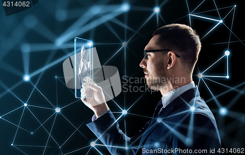 Image of businessman working with transparent tablet pc